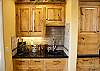 Wet bar next to kitchen and dining room.