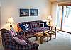 Living room that opens up to the dining room. Has a wood fireplace. Lots of room, nice and cozy. Great for any family.