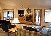 Large spacious livingroom with gas fireplace and New Flat Screen TV.