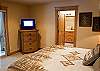 Downstairs king master bedroom with flat screen TV.