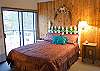 Sweetly decorated upstairs Loft Queen Master Bedroom overlooks the main living area downstairs. Sliding glass door leads outside to the upstairs balcony.