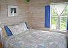 The Master bedroom in "IDRA" offers a queen bed, plus a walk-out crow's nest type deck overlooking Forest Lake.