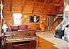 The open concept Living & Dining area, with vaulted ceilings above make great use of the log-home feel in the Berry Patch Vacation Rental located in Sugar Hill, NH.