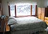 All bedrooms are equally appointed with Queen or Full size beds in the Franconia Slalom Chalet, however we refer to this room as the master due to the amount of light and space it offers.  Quaint wooded views await from every corner of this room professionally managed Franconia Notch Vacations property.