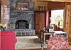 The grand Stone Hearth with fireplace fronted woodstove is the perfect compliment to complete the warmth of the open concept living- dining- kitchen space that makes up just a portion of the pleasures to be found at the Timber Ridge Retreat.