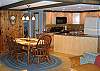 The kitchen and dining areas within the Franconia Slalom Chalet flow wonderfully from one to the other with a center island sink and serving area.  It's great for entertaining many or just one where the views to the living room and exteriors beyond are all obscured.