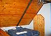 The Sleeping Loft in the Tuck-Away Cabin offers one King size bed plus a Pyramid style Bunk Bed.