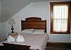 Offering guests one queen size bed and an almost entire suite type feeling, this bedroom offers more space than one might expect otherwise.