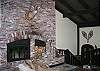 The grand brick hearth fireplace is as outstanding a feature as are the full size windows on the opposing wall.  Sit back and enjoy the great wooded and sunset views or watch the fire for a few hours... Call 800.247.5536 to reserve your relaxation time today!