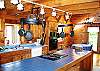 The kitchen opens immediately into the Living & Dining area assuring easy access to family conversation, and during the cooler months the SoapStone Woodstove is sure to keep the discussions warm hearted.