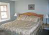 This ground level bedroom offering a King size bed with private attached bath is perfect for folks looking to avoid stairs of any sort while wanting fine furnished comfort.  The cable supported TV/DVD will enable you to fall asleep to the days news, big game or favorite movie.