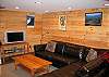 The Family Den area of the First Haus features an over-sized wrap-around couch perfect for playing or watching the favorite game.  Located on the lowest, walk-in level floor of the home this is a perfect retreat from "the real world" just outside or up stairs.