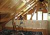 This would be looking out of the master bedroom toward the windows beyond and living/dining areas below.  Ceiling fans above the bed and in the great room further assure your Four Season Franconia Notch comfort