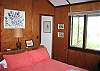 On the entire opposite end of the home from the previous bedroom is this second master style bedroom with private attached bath and windows offering great views of the White Mountain National Forest and Franconia Notch State Park.