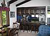 The amply sized kitchen is located just beyond the breakfast bar that breaks through the middle of this frame.  The effect is sort of nice in that is seperates the rooms yet keeps them open enough to make serving dinner or decent conversation a breeze.