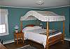 The second bedroom offers this wonderful canopied bed and enjoys its own bathroom.. and it's on the ground floor level.  No Stairs!