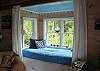 The 5th sleeping arrangement in "IDRA" is this daybed that is wonderfully nestled within a bay window offering views to the lake below.