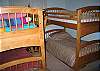 The third and fourth bedrooms of the High Hillside Chalet both feature 2 sets of solid bunkbeds each.  Expect all the lower bunks to be fully outfitted where the top bunks are will be left un-made and without linens or towels to support.