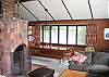 This would be the right side of the large open concept living area.  This time we are looking onto the dining table, with comfortable seating space for at least 8-10 people. Again- lots of windows and tons of natural light will surround you and your guests in this great vacation rental.
