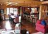 The grand interiors of Franconia's Timber Ridge Retreat make use of an open concept vaulted ceiling Living Room which flows smoothly into the warmly decorated dining space, and finely outfitted kitchen.  Log Home Living- Large with all of NH's White Mountain National Forest surrounding.