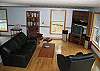 This is the full view of the living room comforts at The Cannon View House. Simple, modern and clean. A Franconia Notch Vacation is sure to be enjoyed relaxing with the views available right from the couchs.