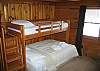 The main floor bedroom is refered to as the #1 bedroom, and features a queen size bed on the lower, and quality twin bed as a top bunk option.