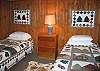 Moving to the fourth bedroom, located in the lower walk-out basement level of the property you find a third set of twin beds.