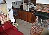Looking down upon the living area and into the kitchen dining area, taken from the stairs heading to the 3rd bedroom...