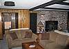 Two bedrooms, a game area, wood burning stove, family TV area and a full bathroom... that is what is to be expected of the lowest level of the #3 Woodchuck Trail Chalet, a professionally managed Franconia Notch Vacations property.
