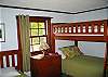 The main floor of the Tram View Chalet enjoys 2 identical outfitted bedrooms, each with one twin bed and one bunk set.  They all have great bedding to go with too!