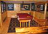Here's a view of the game room looking in on the pool table and dart board at the magnificent Timber Ridge Retreat, a Franconia Notch Vacations professionally managed White Mountain vacation rental homeaway from home.
