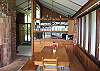 The bench style seating arrangement of the dining table allows much flexibility in the number of guests you wish or need to seat for dinner.  Just before or beyond the dining table is the kitchen so moving dinner to the table will be a snap.