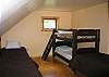 The first bedroom on the second floor offers a multitude of sleeping options.  Seen here are 3 twin beds, plus the bunk-set, and out of view are 2 more twin beds.  Do keep in mind that the maximum occupancy in this home is limited to 9 people...