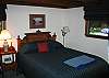 The master bedroom offers a queen size bed and is located on the main floor level, sharing a bath with the twin bedroom thats next door.