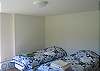 The fourth bedroom of Cannon View is located on the lowest level of the home and is sure to offer summer guests a cool experience.  The great use of windows assures easy viewing of the White Mountain wildlife that is likley to saunter past during your stay.