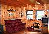 The living area offers two couchs which both feature recliner on each end, plus a few easy chairs and an entertainment center with TV supported by Direct TV signal.  The Game is On!  Book your reservation's for "Izzy's Pearl" today.  800.247.5536