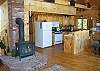 Light, bright and mainly white this kitchen is Just Right for entertaining while you prepare your favorite meal.  The cook in the group will appreciate the gas stove, while the rest of the family enjoys the warmth of the woodstove.