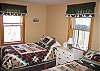 Enjoy two twins beds done in a fresh set of frills in this White Mountain Country style bedroom.  The 2 over-sized windows let lots of light in all year round as well as nice cool breezes come spring, summer & fall.