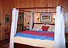 The high ceilings and Four Post California King size bed punctuate the Grand Class quality rating that applies to this home, as so classified by Franconia Notch Vacations who professionally manages and serves this Franconia Notch Timber Ridge Retreat.