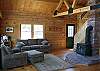 Notice the fact that the woodstove is the center of this room and not a television.  Quiet relaxation was the design and is the delivery of this great living space.  Looking out to where all the light orginates from, you will see nothing but mountains and meadow.
