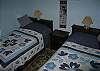 Two twin beds and the same sort of dressor vanity set-up as the master bedroom adds to the ability for guests to devide and seperate for folks who need to get ready by the mirror side.