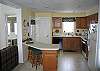 The Kitchen... is continued light, bright and mainly white. The colors here  just work so well and leave you no wonder as to whether it's a clean finish or not.  We assure you, it is.  You will find the full screened porch-sitting area just off this kitchen.