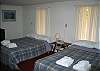 The main bedroom of the Rogaer's Chalet offers 2 Full size beds and offers accommodations for up to 4 guests comfortably.  The White Mountain National Forest is right outside those windows by the way....