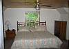 The large master bedroom of Strawberry Place enjoys French Doors with a full bathroom just outside of them.