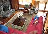 The classic interiors of the Timber Ridge Retreat include the Antler Chandelier, a grand Stone Hearth with woodstove insert fireplace, great views from every window and lots of comfy seating to enjoy the natural warmth of this grand Franconia Notch log home.