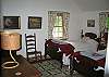 Outfitted with 2 twin beds, this is the third bedroom within Butternut's interior.  Outside of this bedrooms door is the open summer porch as seen in the exterior photo of the "Shade Side" of things.