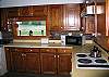 The over-sized galley style kitchen offers plenty of space for family members to move about in ease with a full size washer and dryer nicely tucked away here.