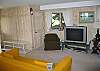 The lower level of the High Hillside Chalet is not only the level of entry, it also features this enjoyable TV Den area perfect for lounging around playing games or watching movies should a rainy day set in.