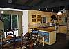 As seen here, the open style kitchen flows nicely right over and into the dining area with a breakfast bar-serving area so perfectly seperating the two spaces.