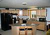 Very well equipped, the kitchen is apart of the open floor plan kitchen/living/dining area.  The cook is not be left out of the fun at the Franconia Cannon View House.